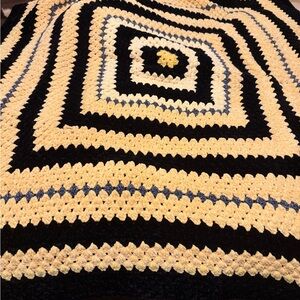 This is a handmade granny square crocheted throw blanket